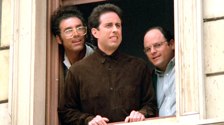 Seinfeld, Kramer, Jerry and George looking at the Puerto Rican paradegoers destroying their car