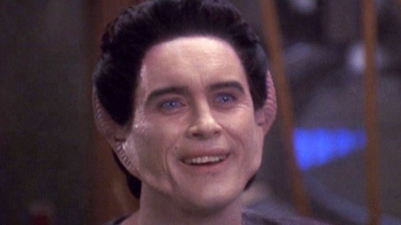 Weyoun smiling brightly and looking up off-camera