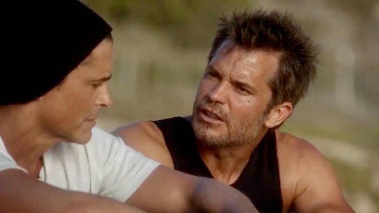 Dean and Timothy seated on the beach and talking
