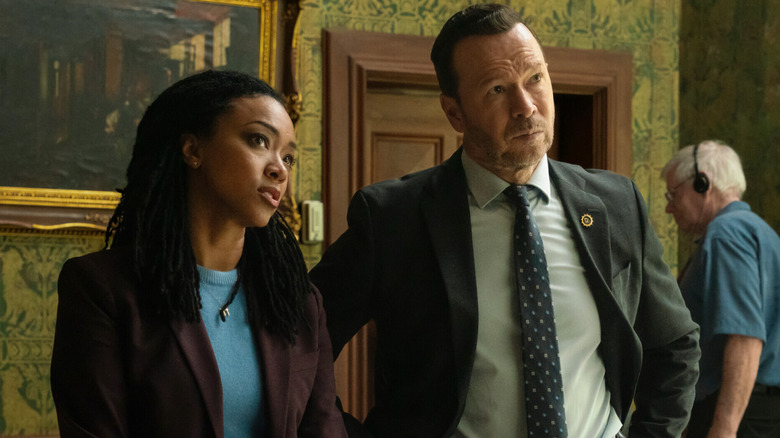 Lena Silver and Danny Reagan standing next to each other while investigating a crime scene