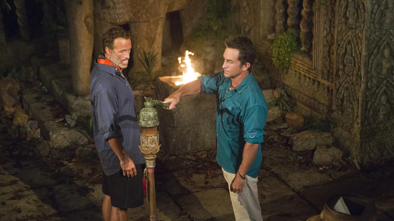Andrew Savage gets his torch snuffed by Jeff Probst on Survivor: Cambodia