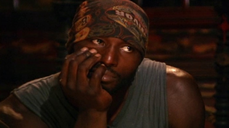 James with his chin in his hand at tribal council on Survivor: China