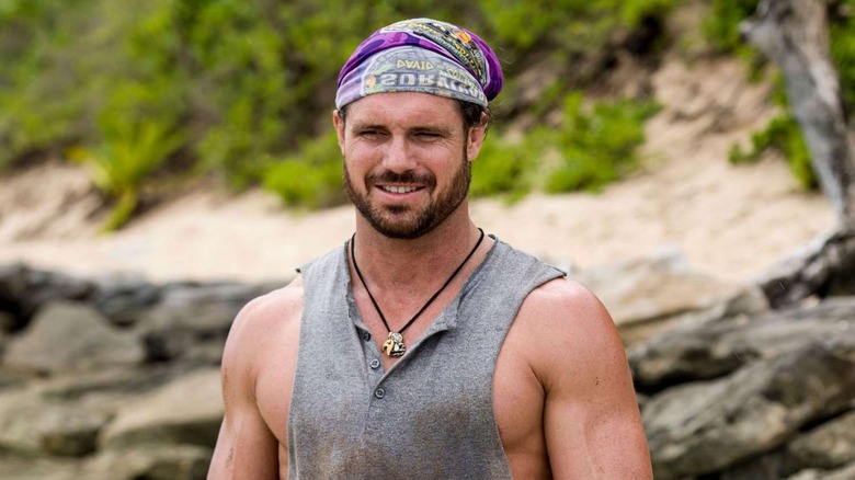 John standing on the beach squinting on Survivor: David vs. Goliath