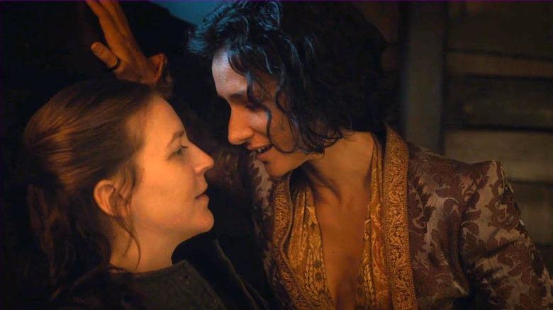 Gemma Whelan as Yara Greyjoy sitting next to Indira Varma as Ellaria Sand with hand above her head leaning into her on Game of Thrones