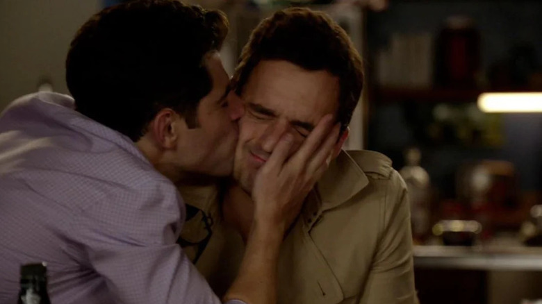 Max Greenfield as Schmidt kissing an unwilling Jake Johnson as Nick on the cheek on New Girl