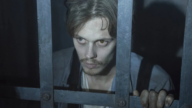 Bill Skarsgård as The Kid, looking through bars in Castle Rock.