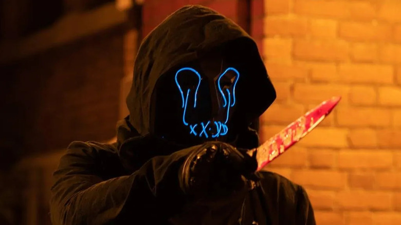 The Druid holds up a knife in Slasher.