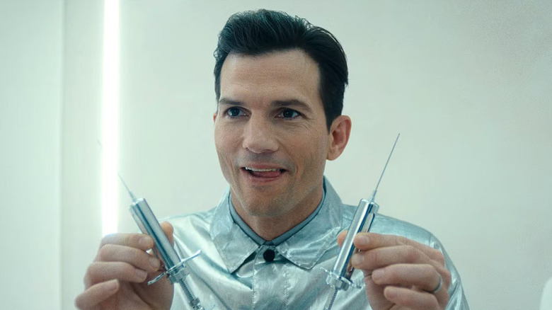 Ashton Kutcher as Byron Forst, holding syringes in The Beauty.