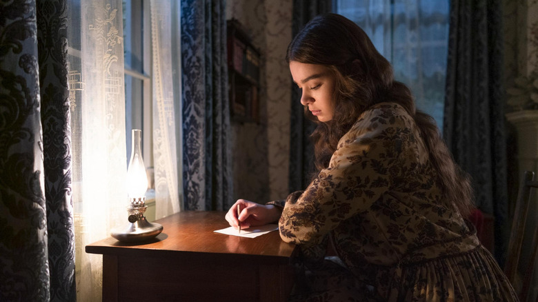 Emily writing at desk