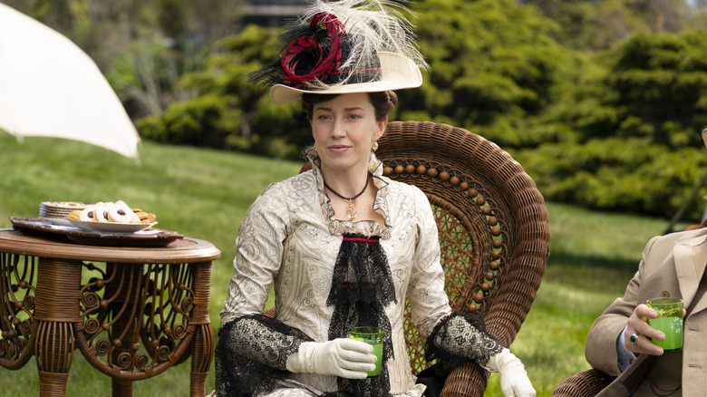 Bertha Russell on wicker chair