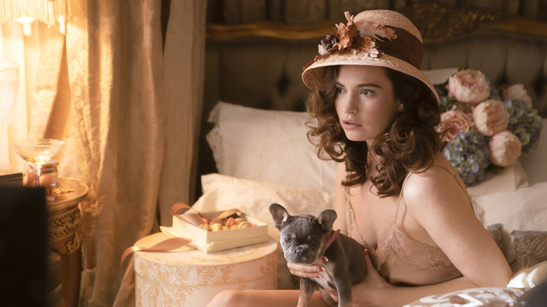 Linda sitting on bed with puppy