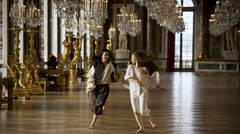 Louis and girl running through palace