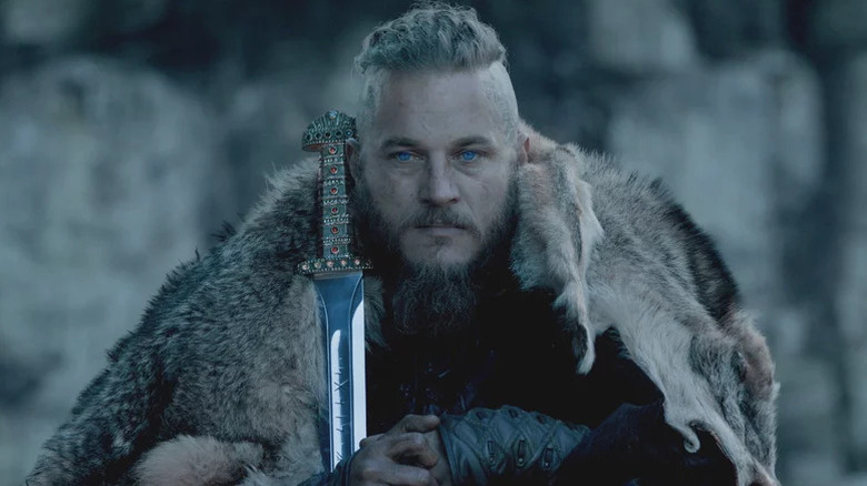Travis Fimmel as Ragnar with sword resting in front of him in Vikings