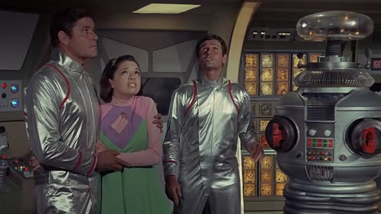 The Robinson family and robot brace themselves while their ship is in turbulence.