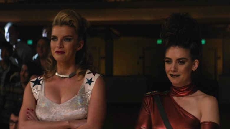 Debbie Eagan and Ruth Wilder standing side by side and smiling on GLOW S1E10