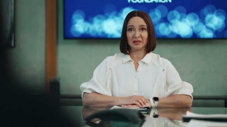 Molly Wells sitting in the conference room with a confused expression on Loot S1E2