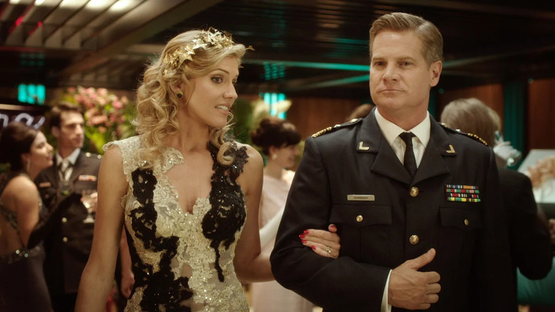 Viondra (Tricia Helfer) and William Denninger (Brian Van Holt) gladhand in Ascension