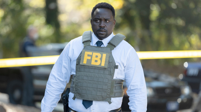 Tayo (Brian Tyree Henry) examines a crime scene in Class of '09