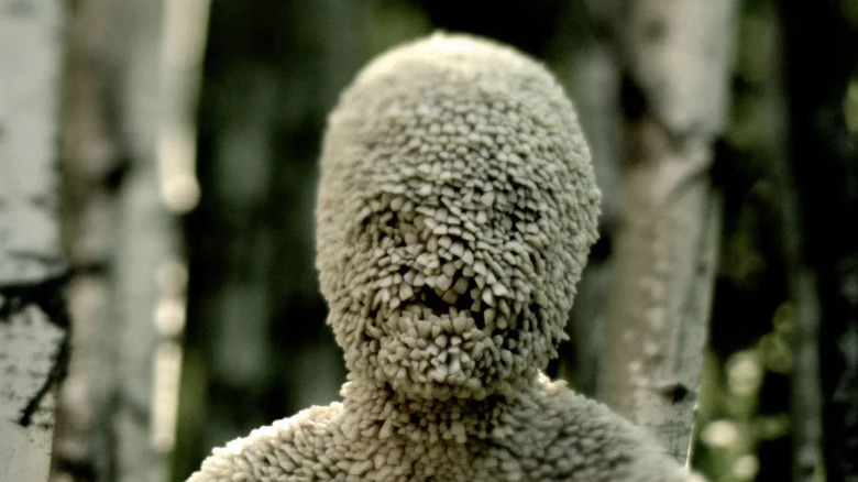 Cassandra Consiglio's Tooth Child standing in the woods on Channel Zero