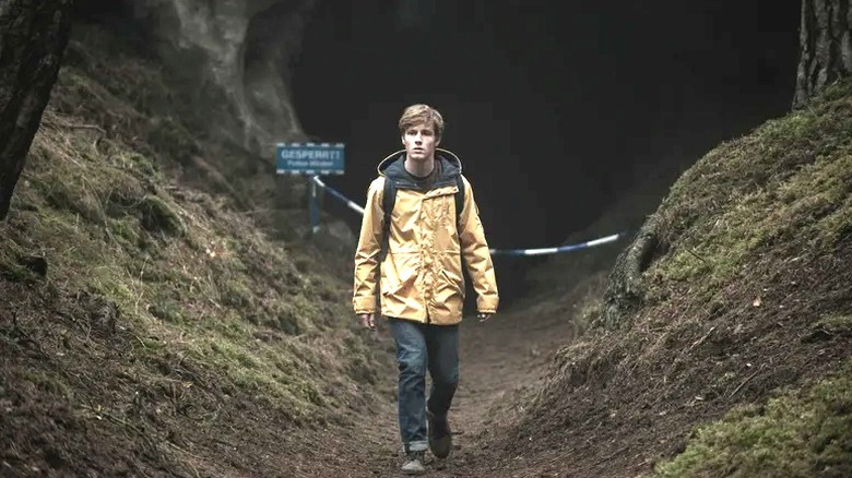 Louis Hofmann's Jonas Kahnwald wearing a backpack and yellow jacket on Dark