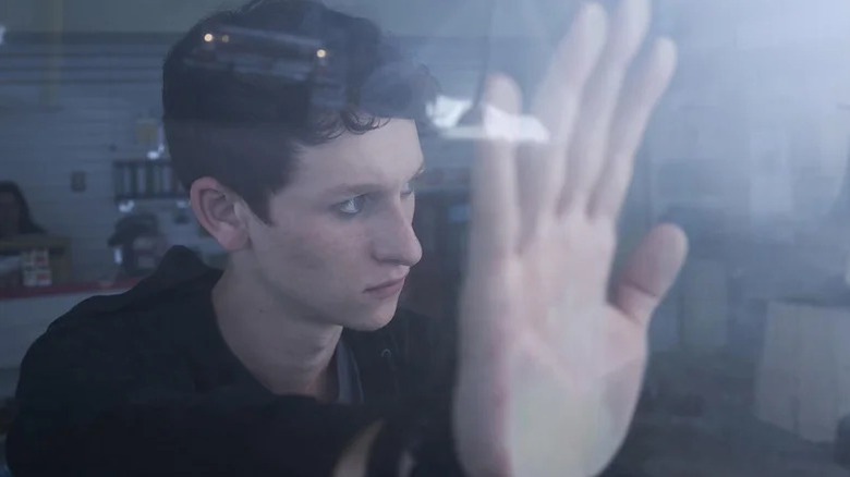 Russell Posner's Adrian Garff holding his hand against a window on The Mist
