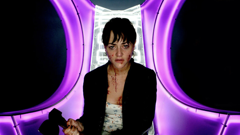 Kelly wields an axe inside the confessional room in "Dead Set" (2008)