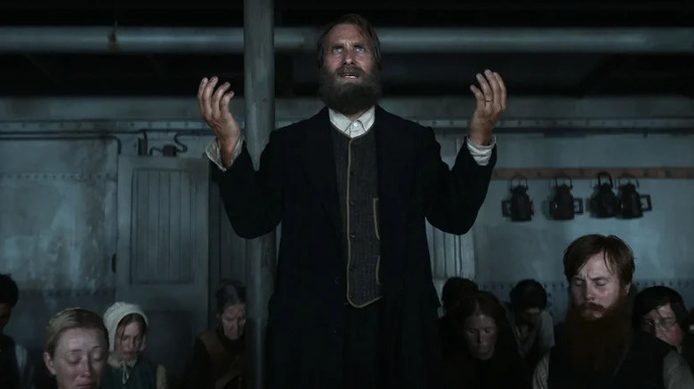 Alexandre Willaume as Anker preaching to cabin of passengers in 1899