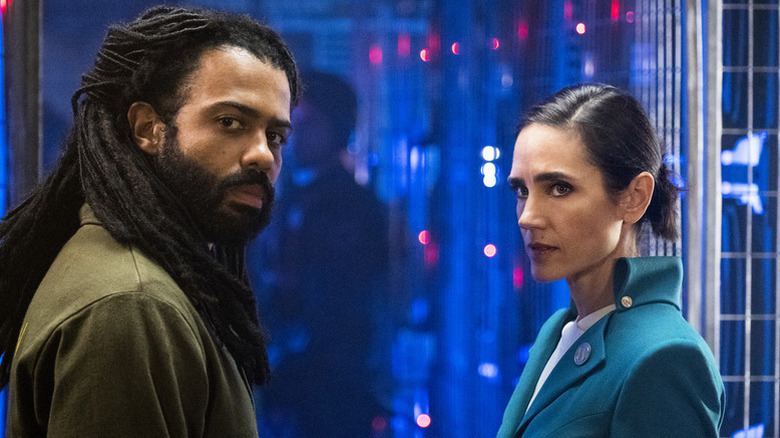 Daveed Diggs as Layton standing next to Jennifer Connelly as Melanie in Snowpiercer