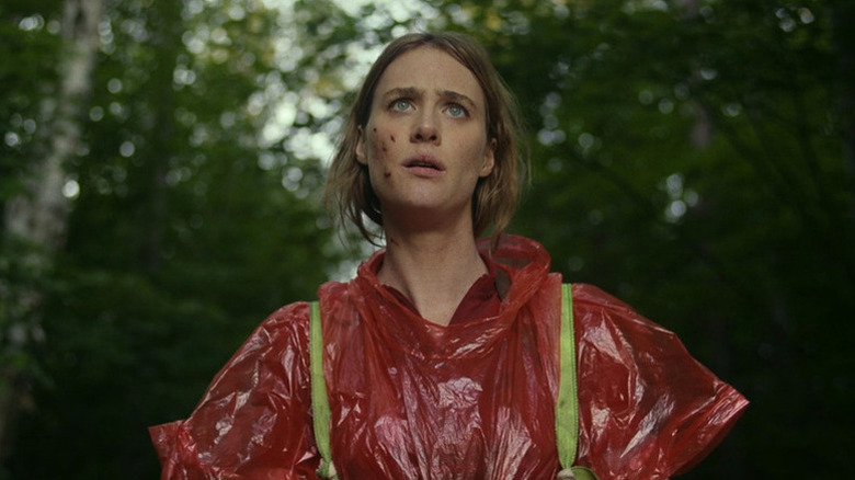 Mackenzie Davis as Kirsten wearing red poncho in Station Eleven