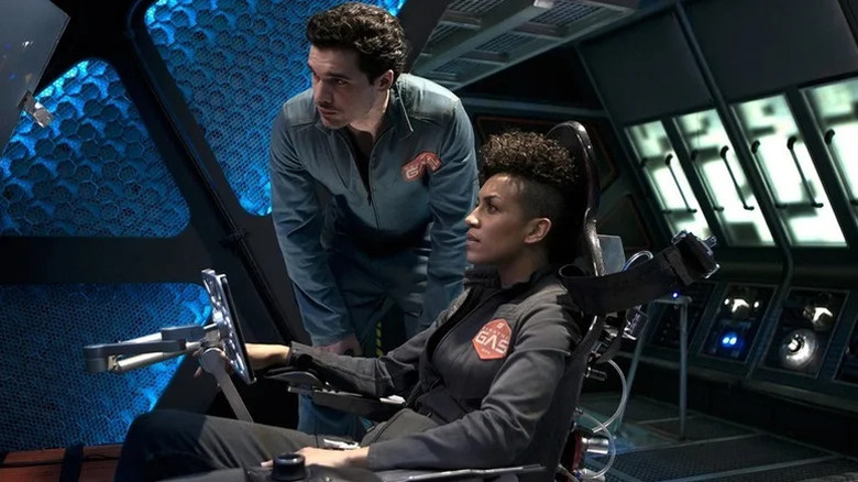 Dominique Tipper as Naomi Nagata sitting at spaceship command with Steven Strait as James Holden standing next to her in The Expanse