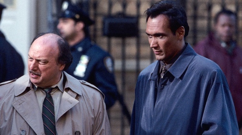 Andy Sipowicz (Dennis Franz) and Bobby Simone (Jimmy Smits) speak next to police officers in NYPD Blue