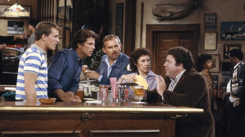 Woody Harrelson, Ted Danson, John Ratzenberger, Rhea Perlman, and George Wendt gathered around bar on Cheers