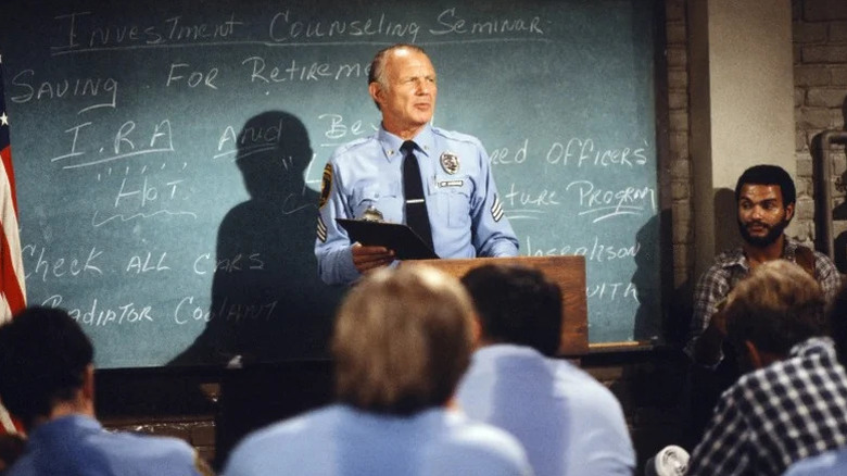 Michael Conrad standing in front of blackboard as Sgt. Phil Esterhaus in Hill Street Blues