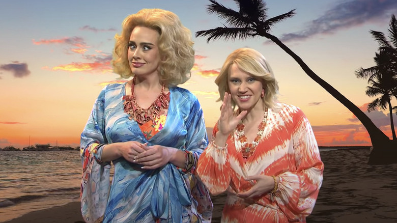 Adele and Kate McKinnon with blonde wigs on a beach on Saturday Night Live