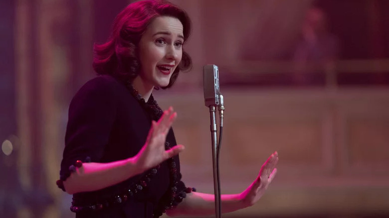 Rachel Brosnahan as Mrs. Maisel standing in front of microphone in The Marvelous Mrs. Maisel