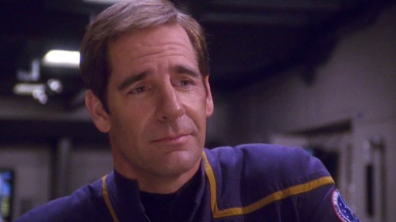Jonathan Archer (Scott Bakula) stands with a wistful look on his face in Star Trek: Enterprise