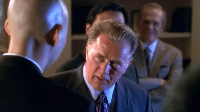 Jed Bartlett (Martin Sheen) greets a bald man in the Oval Office in The West Wing