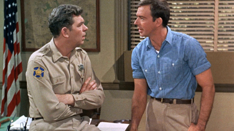 Andy Taylor (Andy Griffith) speaks with Sam Jones (Ken Berry) in his office in Mayberry R.F.D.