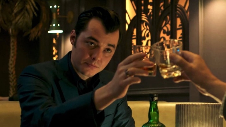 Alfred Pennyworth (Jack Bannon) toasts a drink in Pennyworth