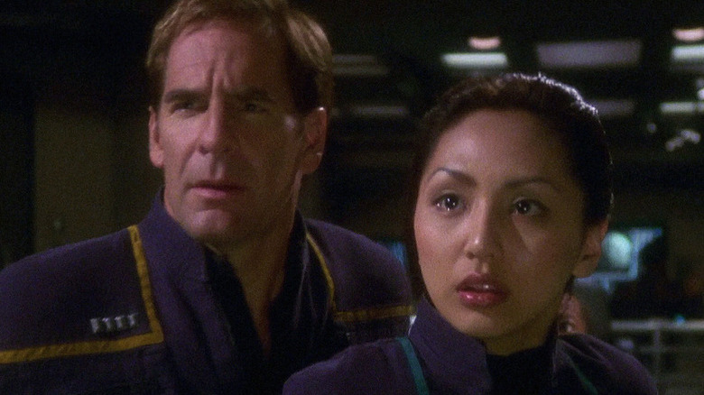 Jonathan Archer (Scott Bakula) and Hoshi Sato (Linda Park) look emotional and shocked in Star Trek: Enterprise