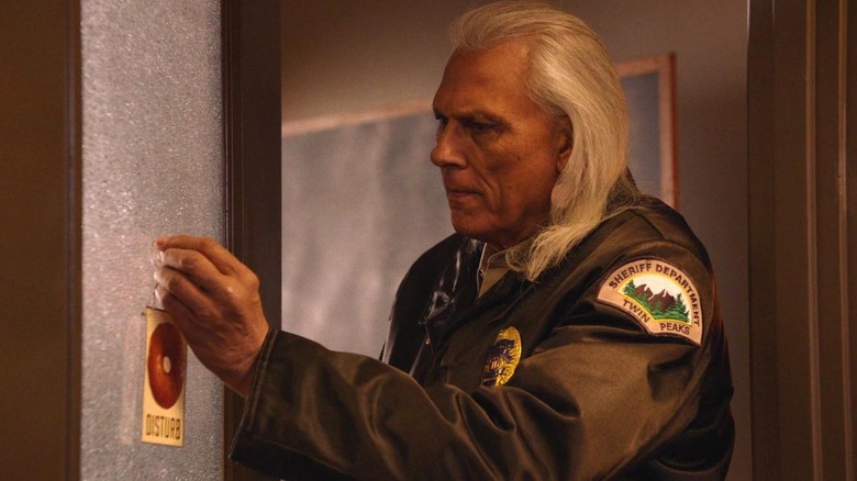 Deputy Hawk (Michael Horse) putting a sign on a door in "Twin Peaks: The Return"