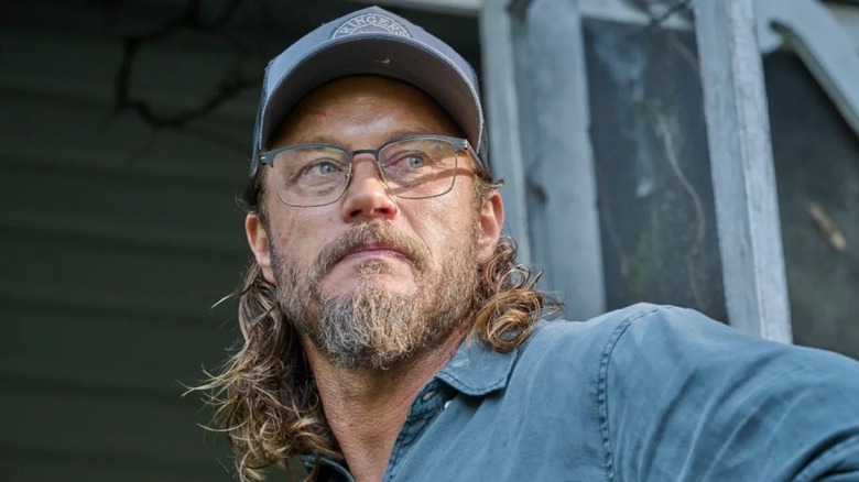Detective James Cormack in a blue shirt and glasses in "Black Snow"