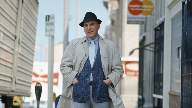 Telly Savalas poses as Kojak on a city street