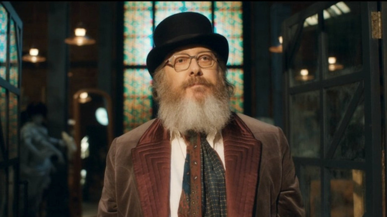 Ultron with black top hat, grey beard, and brown suit in "VisionQuest"