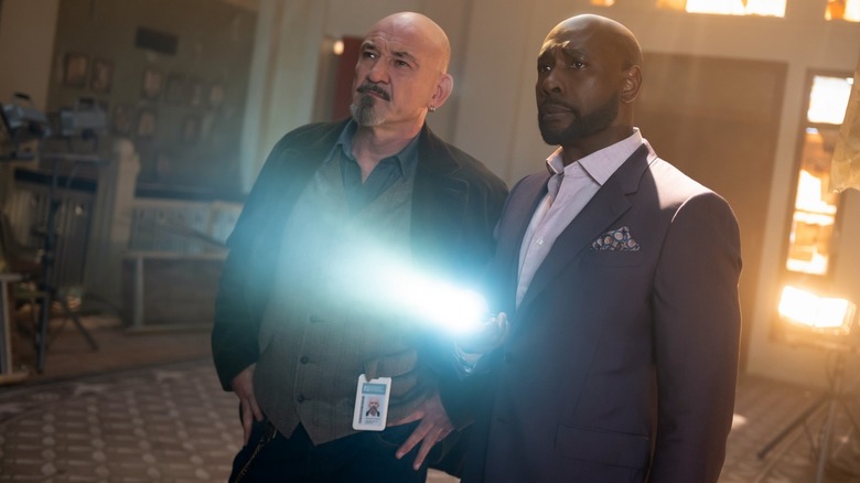 Ritchie Coster as Shinwell and Morris Chestnut as Watson shine a flashlight in Watson