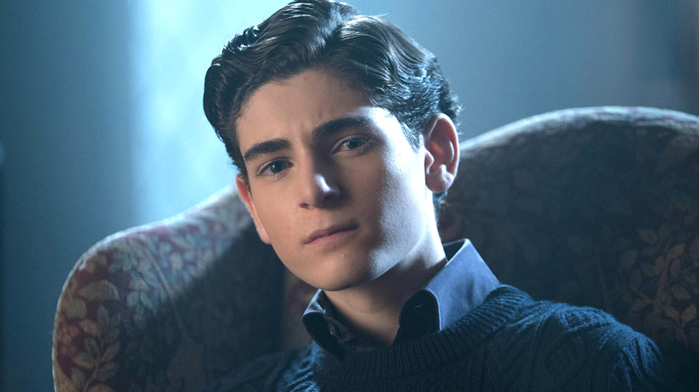 Bruce Wayne sitting in a chair in the dark, wearing a sweater in "Gotham"