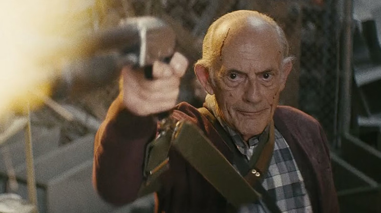 Christopher Lloyd as David Mansell firing a gun in Nobody