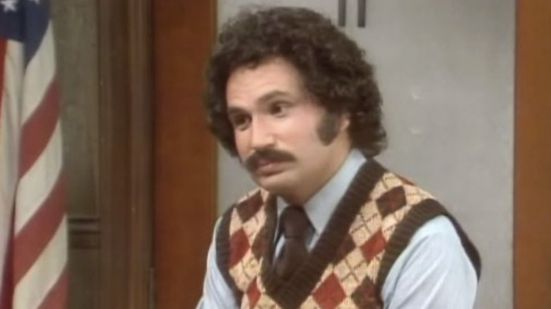 Gabe Kotter standing in front of the American flag in his classroom