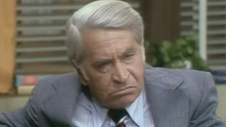 Michael Woodman looking annoyed in his office