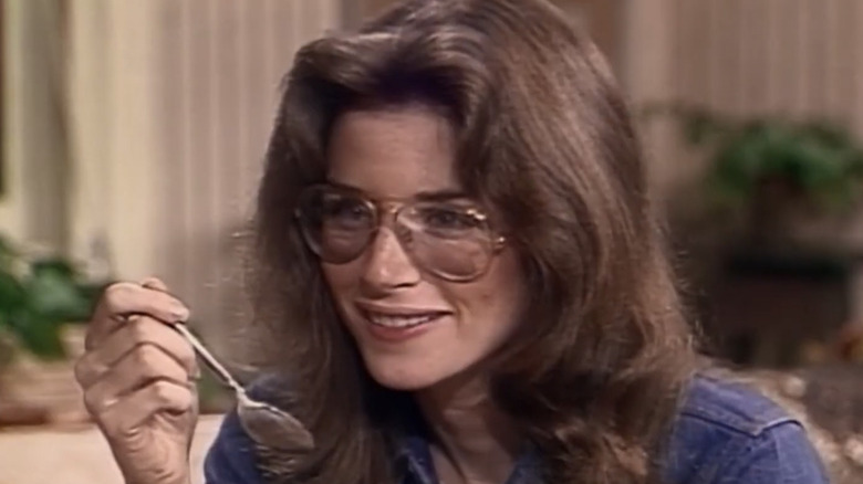 Julie Kotter holding a spoon and laughing